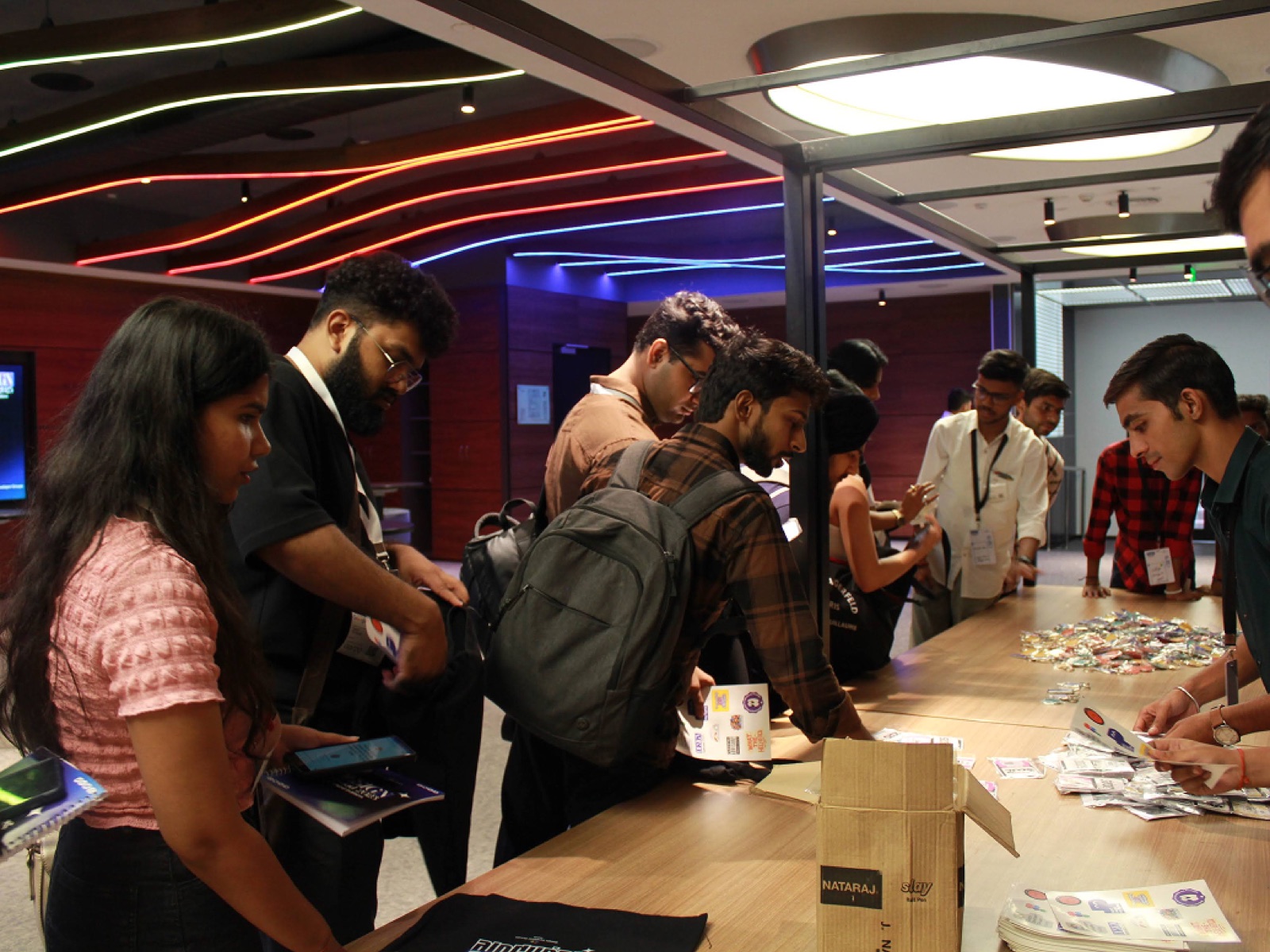 Attendees collecting badges and swag at the registration desk