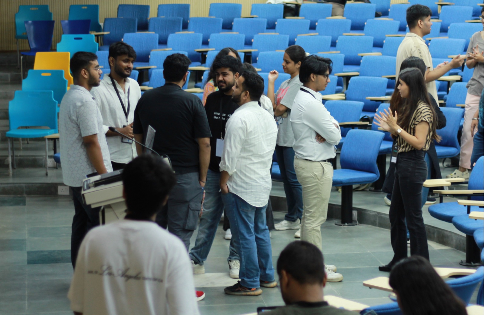 Attendees talking between sessions in the auditorium