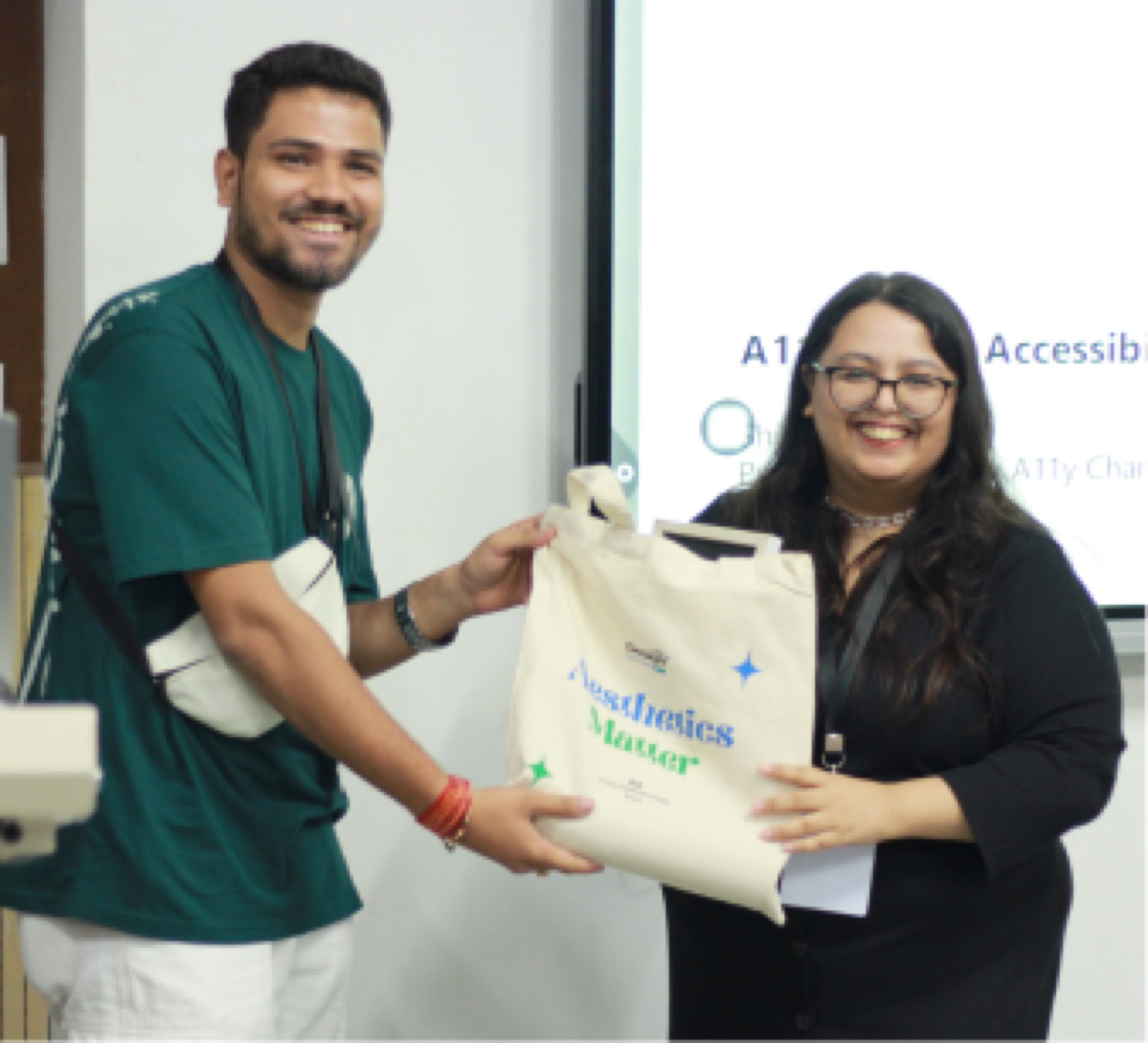 An attendee receiving a tote bag from an organiser